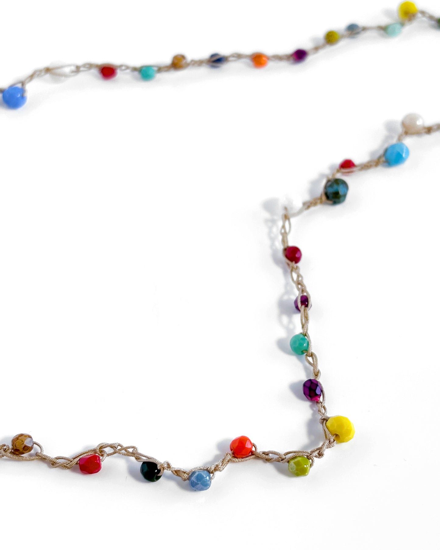 Long crochet necklace with small multicolored crystals